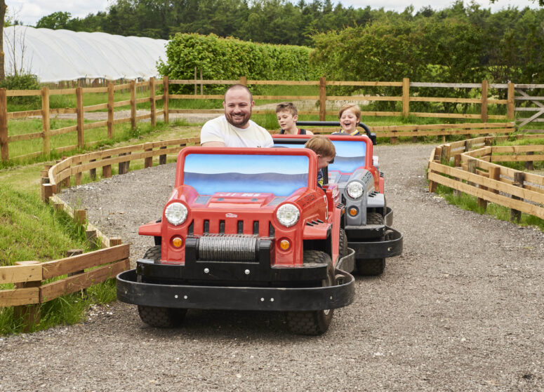 Family on the jeeps driving around the track