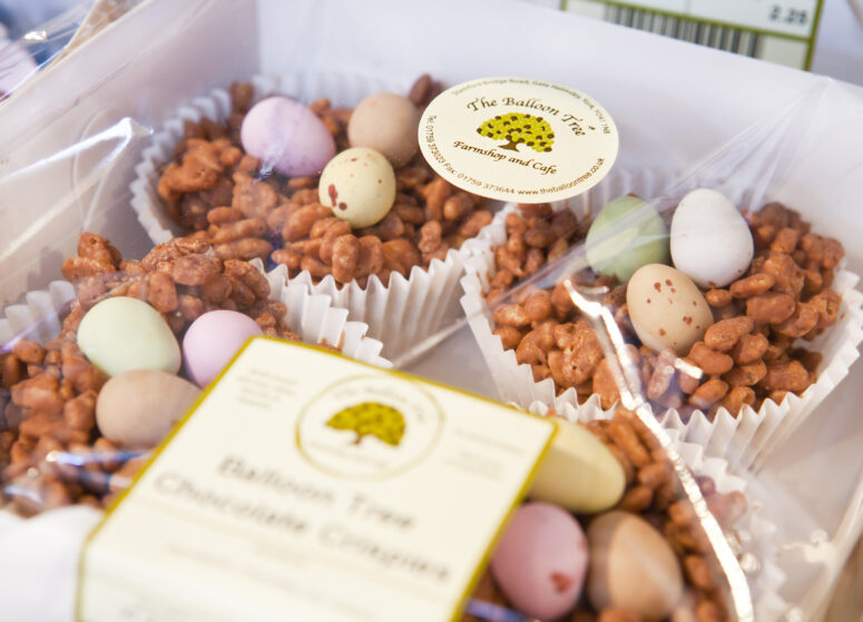 Four chocolate crispy buns with mini chocolate eggs on the top